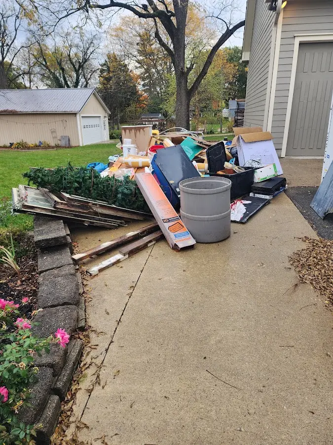 Dumpster being loaded with debris for Residential Dumpster Rental in Quincy